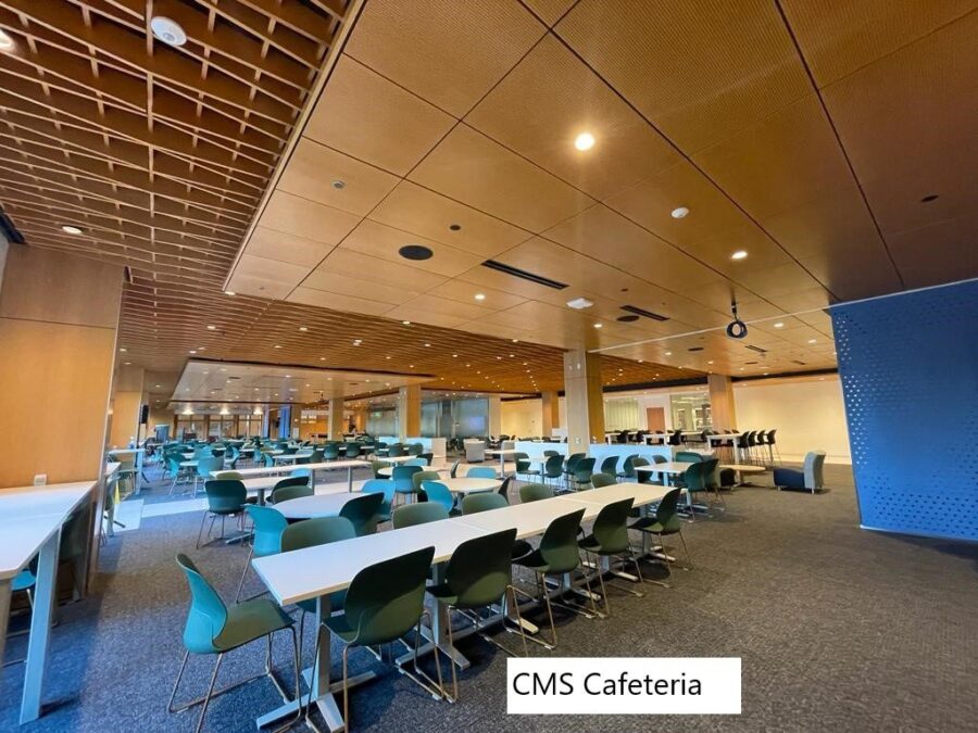 A large indoor common area filled with long tables.