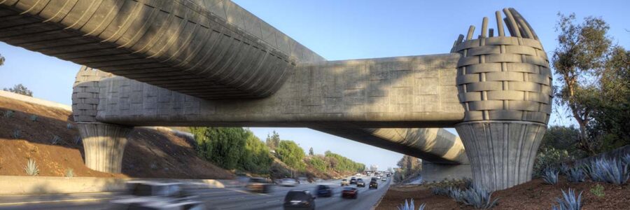 A metro bridge spanning over a busy interstate road.