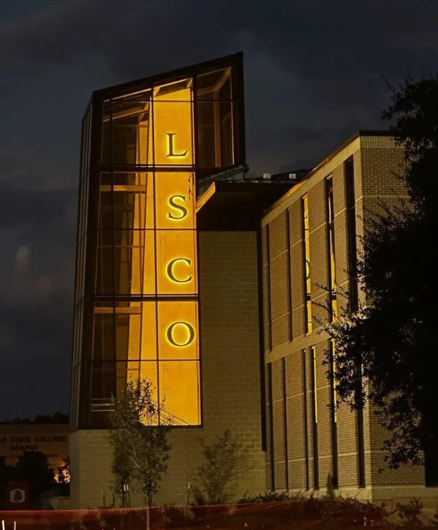 A large Glass Building with a LSCO sign.