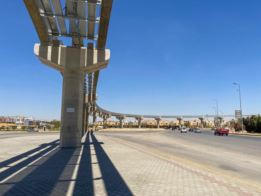 An elevated monorail track in the middle of the city.