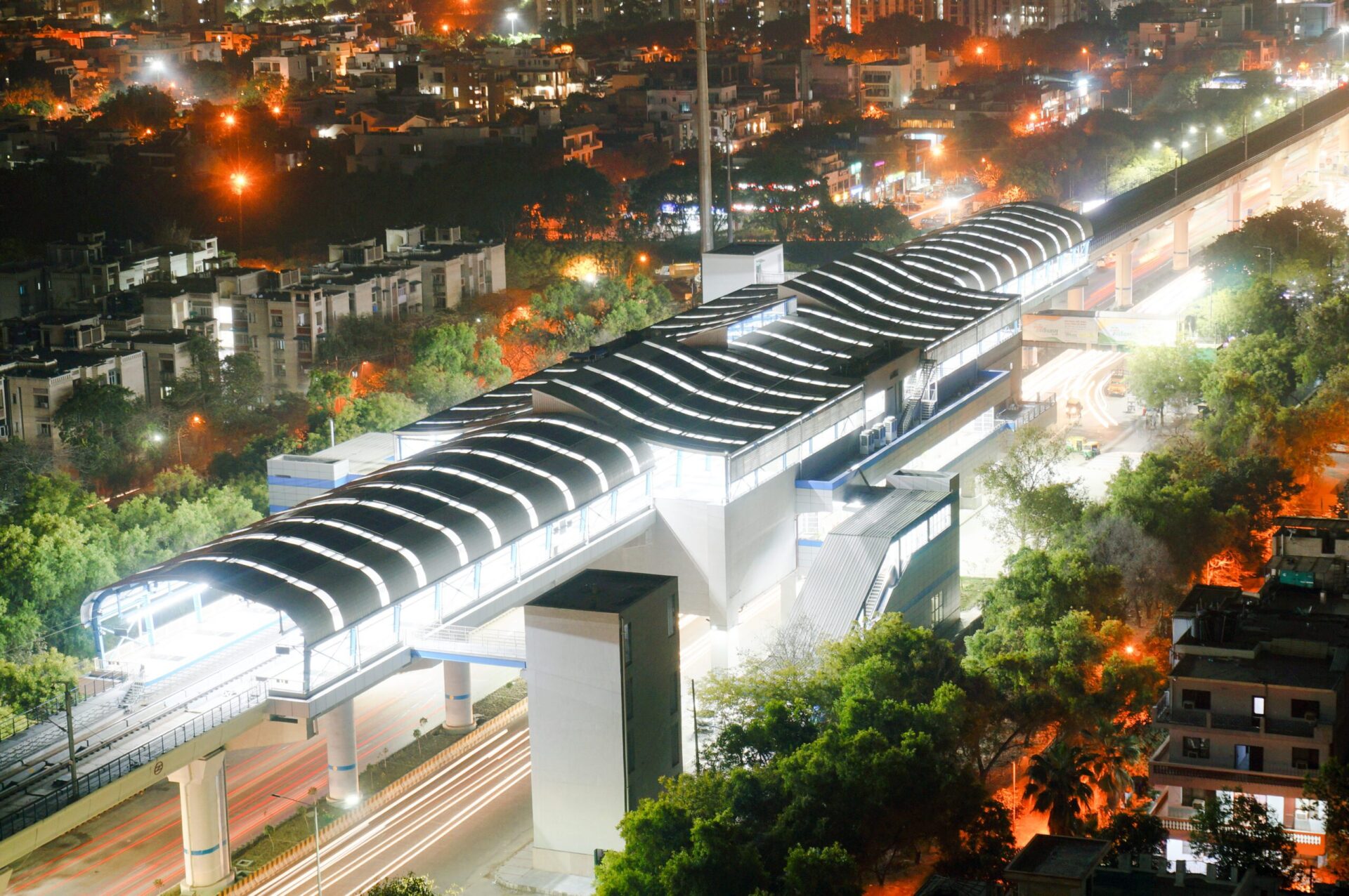 Aerial,Shot,Of,Lit,Metro,Sation,With,Trails,From,Leaving