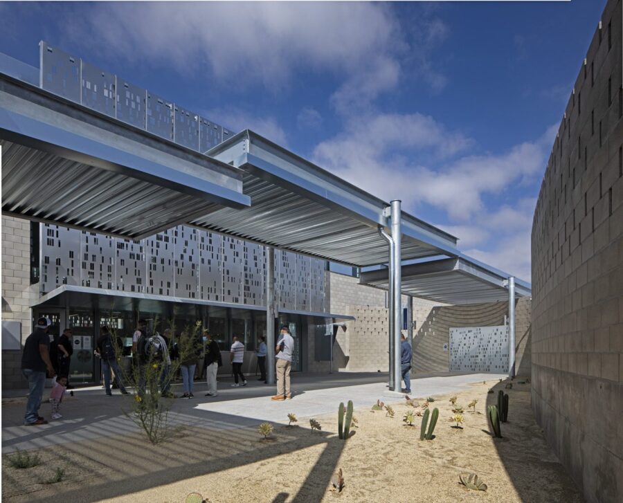 The Front Entrance of a building with a small crowd of people