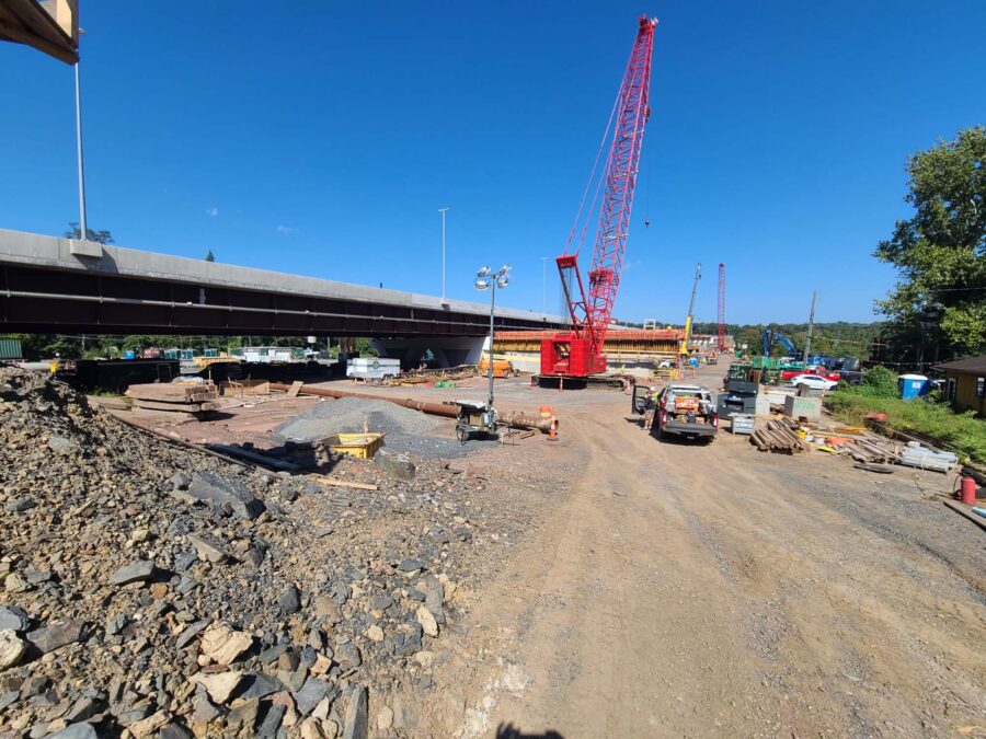 A construction site with a large red crane