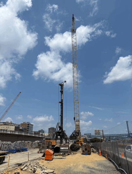A large crane in a construction site in the middle of Philadelphia. 